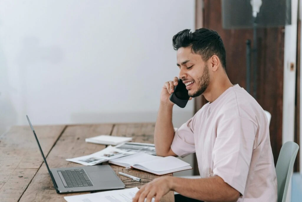 Smiling professional on phone call at workspace